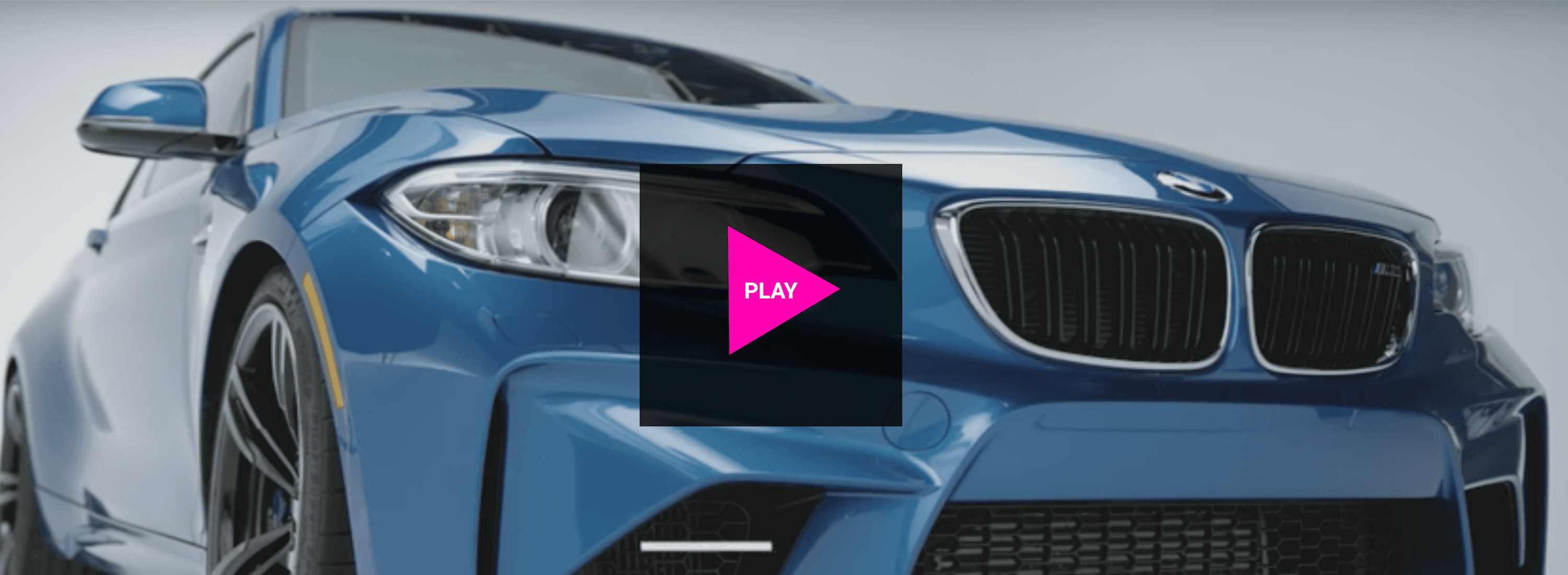 A blue bmw m2 is sitting on top of a white surface.